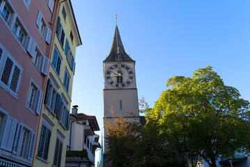 Fototapeta na wymiar Church tower with largest church clock face in Europe of medieval church St. Peter at the old town of Zürich on a sunny late summer day. Photo taken September 22nd, 2022, Zurich, Switzerland.