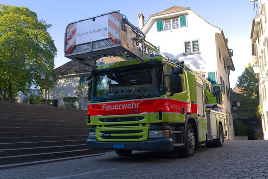 Parked fire engine with mobile ladder at square named St. Peterhofstatt at the old town of Zürich on a late summer morning. Photo taken September 22nd, 2022, Zurich, Switzerland.