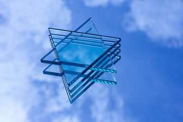 A clear glass placed on a mirror reflects the Star of David, a hexagram formed by overlapping two equilateral triangles in an upside-down manner. Known as the national symbol of the nations of Israel,