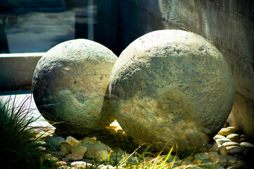 Front yard boulders with natural stones and hidden grass in art instilation or decorative yard design for modern home in city