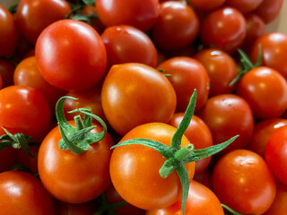 Lots of small round red fresh natural cherry tomatoes. Background, texture