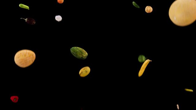 various fruits and vegetables flying about the scene with black background and alpha mask to extract and use over another background