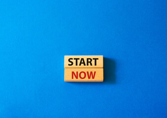 Start now symbol. Wooden blocks with words Start now. Beautiful blue background. Business and Start now concept. Copy space.
