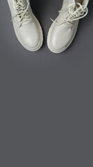 beige women's shoes on a gray background. Autumn shoes. Vertical image