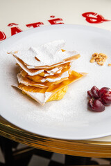 Dessert millefeuille with custard and cherry