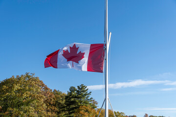 canadian flag against blue sky