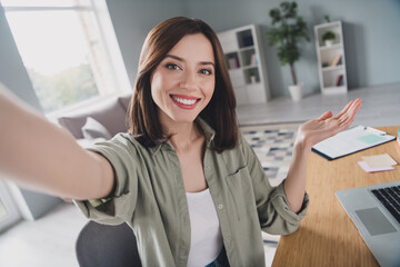 Photo of attractive positive person sitting chair make selfie recording video spacious office indoors