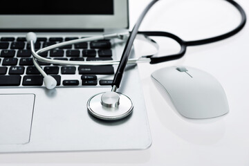 Stethoscope on the keyboard of laptop
