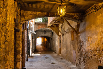 Historic XIII century Rue Obscure Dark Covered Street underground passageway under harbor front houses in old town quarter of Villefranche-sur-Mer in France