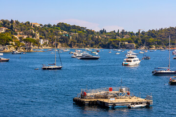 Panoramic view of harbor and beach onshore Azure Cost of Mediterranean Sea in Villefranche-sur-Mer resort town in France