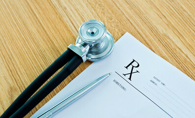 Medical prescription, stethoscope and pen on doctor desk