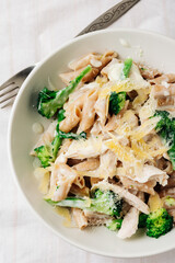 Whole grain penne pasta with chicken and green vegetables.