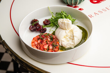 Burrata with strawberries, basil and cherries