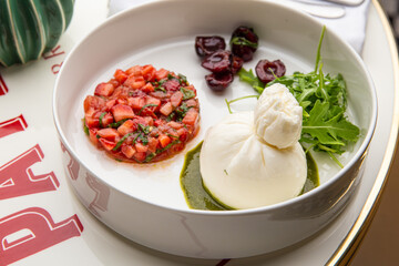 Burrata with strawberries, basil and cherries