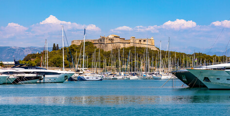 Fototapeta na wymiar Panoramic view of harbor, port and yacht marina and Fort Carre castle offshore Azure Cost of Mediterranean Sea in Antibes resort town in France