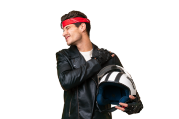 Young caucasian man with a motorcycle helmet over isolated background suffering from pain in shoulder for having made an effort