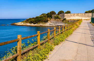 Panoramic view of French Rivera rocky coastline of Pointe Belaye cape at Antibes resort city harbor...