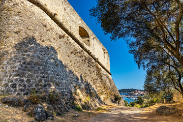 Defense walls and towers of medieval fortress Fort Carre castle in Antibes resort city onshore...