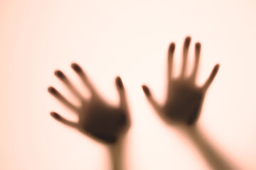 Blurred shadows of hands behind glass, concept of ghosts, zombies, walking corpses - obrazy, fototapety, plakaty