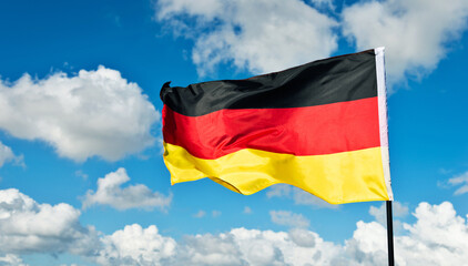 German flag waving against blue sky