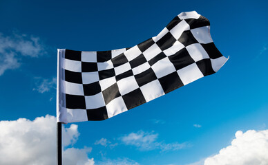 Checkered flag on blue sky