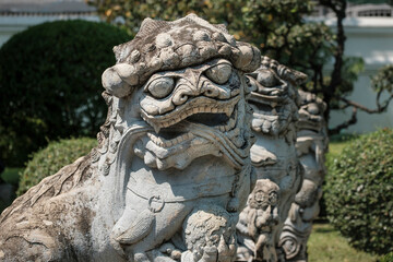 Fototapeta na wymiar statues of chinese guardian lions at Wat Arun temple