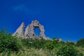 ruins of an old building with a huge hole in a wall