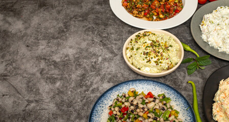 Traditional Turkish and Greek dinner appetizer table. Mediterranean appetizer concept. Copy space. Cretan pate, dry cowpea salad, roasted eggplant salad, carrot tarator, gavurdagi salad