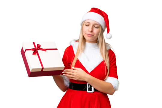 Young blonde woman with christmas hat and holding a gift over isolated chroma key background with sad expression