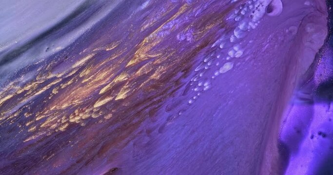 Lilac-gold bright colorful paint abstraction background. Shiny golden flowing, spread vivid deep purple ink. Creative artistic painting. Fluid artwork backdrop. Acrylic move pattern texture. Color art
