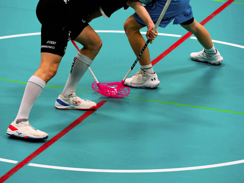 Floorball players wait for the referees whistle and the start of the match.