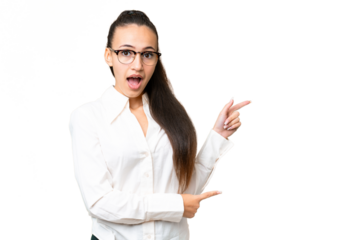 Young Arabian woman over isolated chroma key background surprised and pointing side