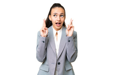 Young Arabian woman over isolated chroma key background with fingers crossing and wishing the best