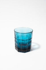 Beautiful blue glass for drinks on a white clean background