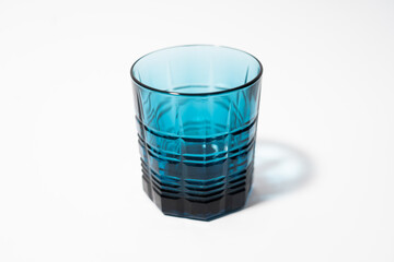 Beautiful blue glass for drinks on a white clean background