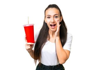 Young Arabian woman holding soda over isolated chroma key background shouting with mouth wide open