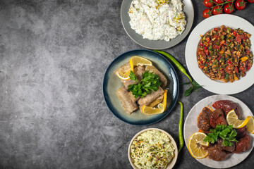 Top view traditional Turkish and Greek dinner appetizer table. Mediterranean appetizer concept. Copy space. Cretan pate, roasted eggplant salad, gavurdagi salad, stuffed peppers, cabbage rolls