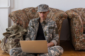 Fototapeta premium Soldier holding laptop. Military education concept