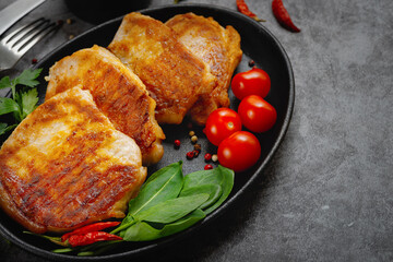 Grilled pork steaks in a pan with spices with copy space