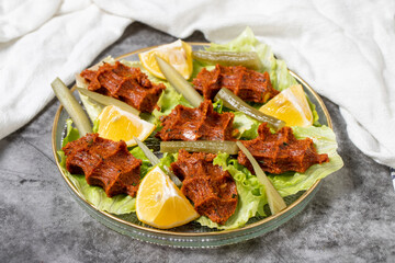 Raw meatballs (cig kofte) on dark background. Turkish cuisine delicacies. close up