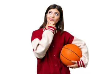 Young Russian woman playing basketball over isolated chroma key background having doubts