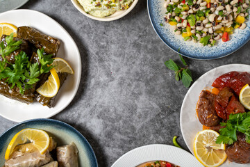 Top view traditional Turkish and Greek dinner appetizer table. Mediterranean appetizer concept. Empty space for text. Raw meatballs, roasted eggplant salad, stuffed olives, stuffed peppers