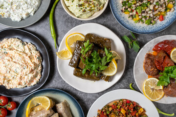 Top view traditional Turkish and Greek dinner appetizer table. Mediterranean appetizer concept. Raw meatballs, roasted eggplant salad, stuffed olives, stuffed peppers, gavurdagi salad