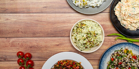 Top view traditional Turkish and Greek dinner appetizer table. Mediterranean appetizer concept. Copy space. Cretan pate, dry cowpea salad, roasted eggplant salad, carrot tarator, gavurdagi salad