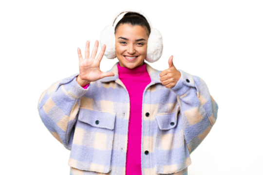 Young woman wearing winter muffs over isolated chroma key background counting six with fingers