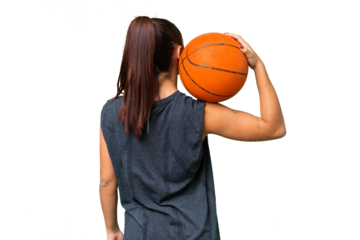 Young beauty woman over isolated chroma key background playing basketball in back position