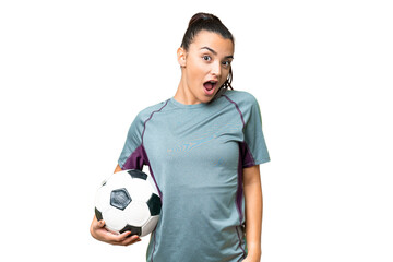 Young football player Woman over isolated chroma key background with surprise facial expression