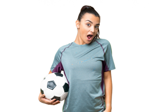 Young football player Woman over isolated chroma key background with surprise facial expression