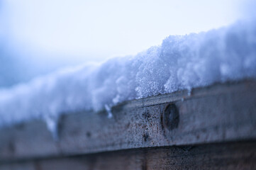 Thick snow on a garden fence