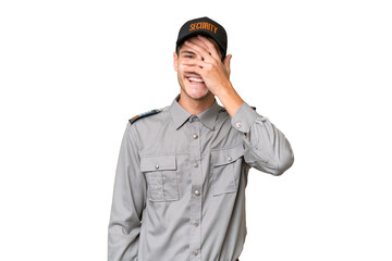 Young security man over isolated background covering eyes by hands and smiling